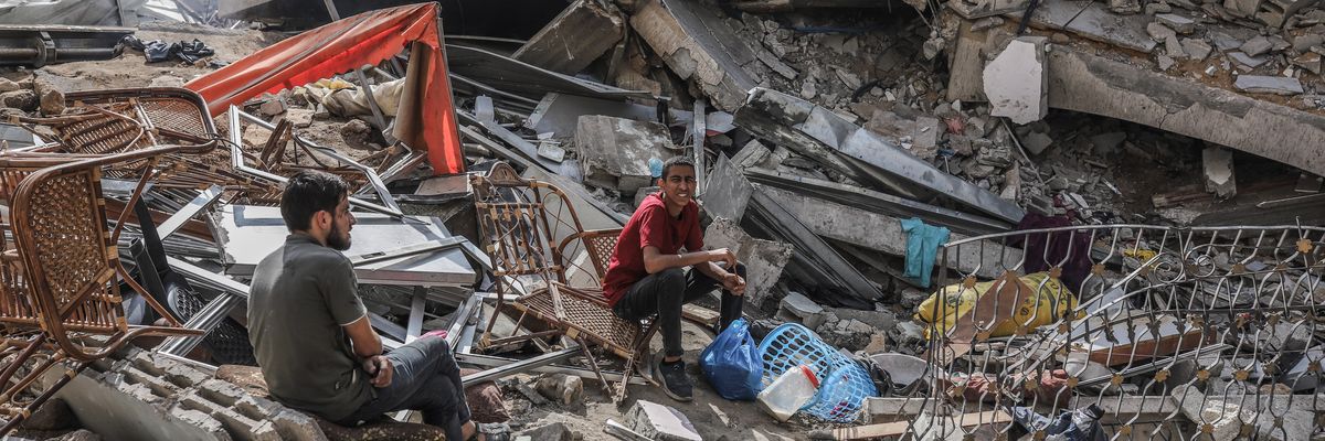 Palestinians inspect a destroyed building