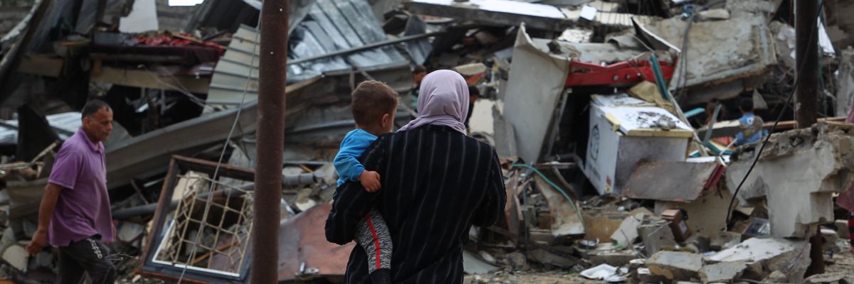 Palestinians inspect houses destroyed by Israeli airstrikes