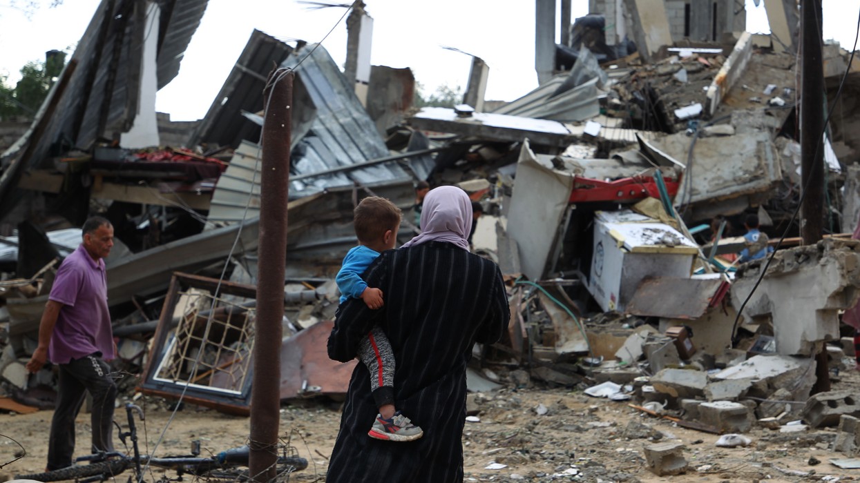 Palestinians inspect houses destroyed by Israeli airstrikes