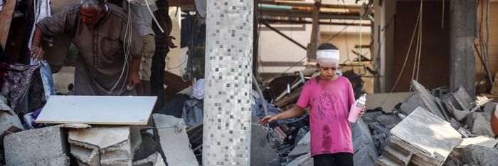 Palestinians inspect rubble in central Gaza