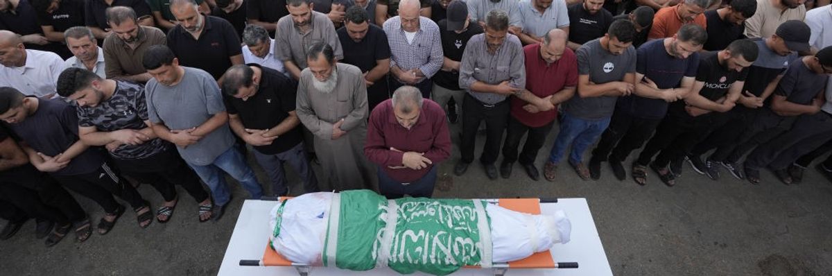 Palestinians mourn a child killed by Israeli occupation forces in the West Bank city of Jenin