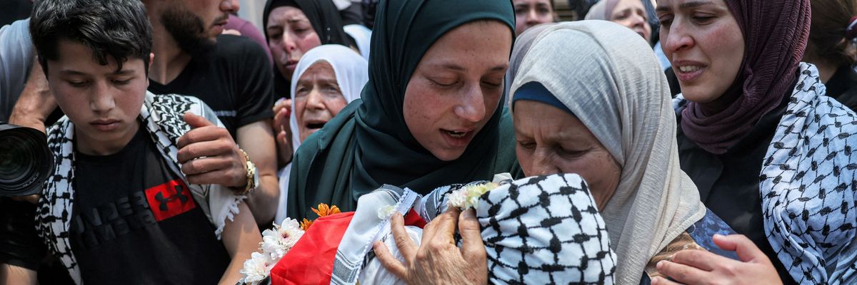 Palestinians mourn a child killed by Israeli troops