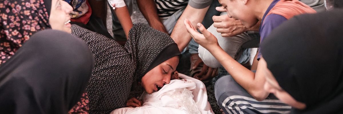 Palestinians mourn a relative killed in an Israeli strike