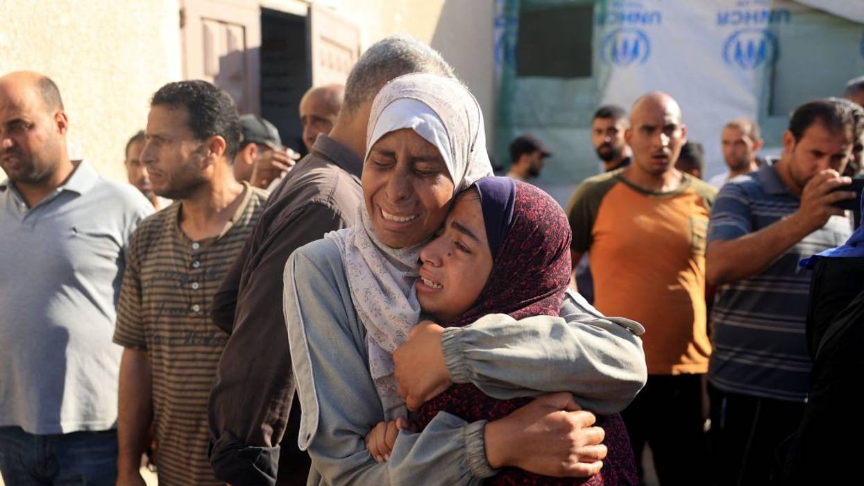 Palestinians mourn over the bodies of loved ones