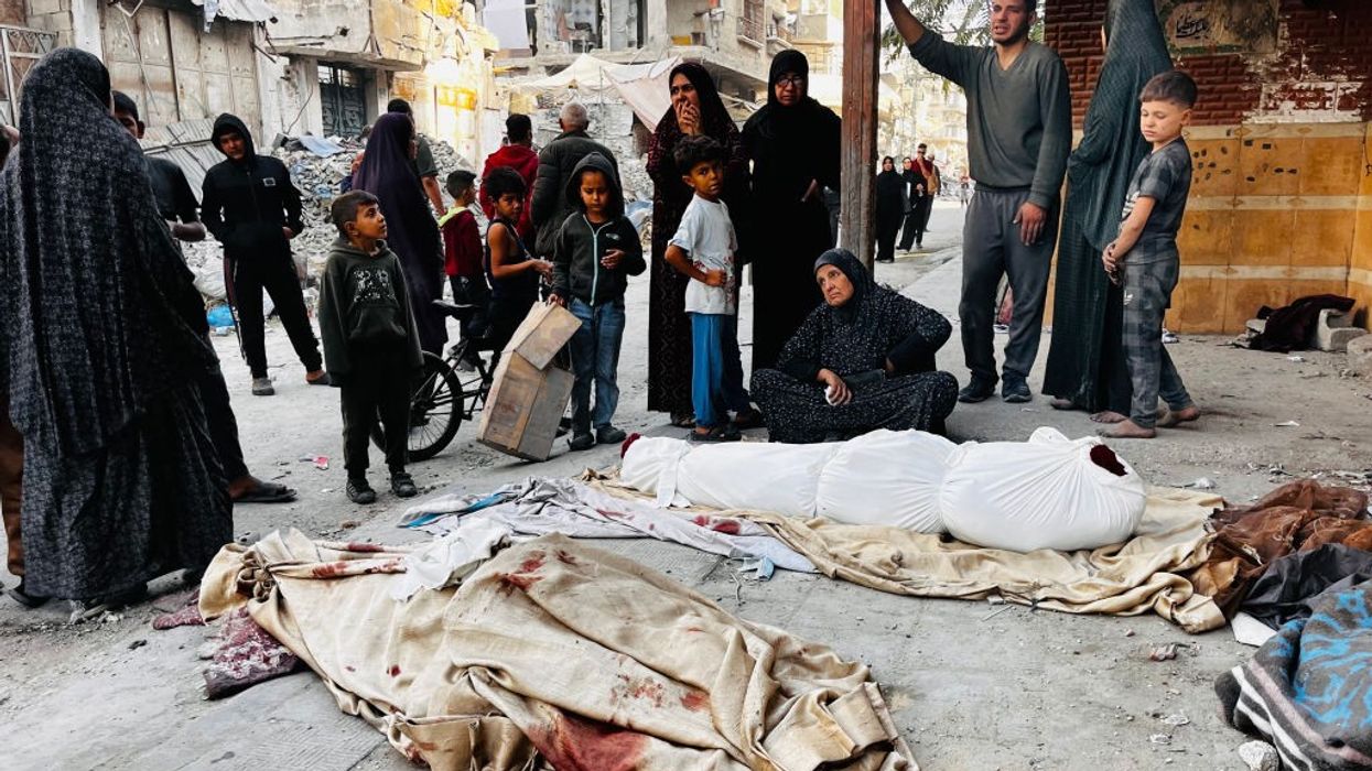 Palestinians mourn over the bodies of relatives killed by an Israeli attack