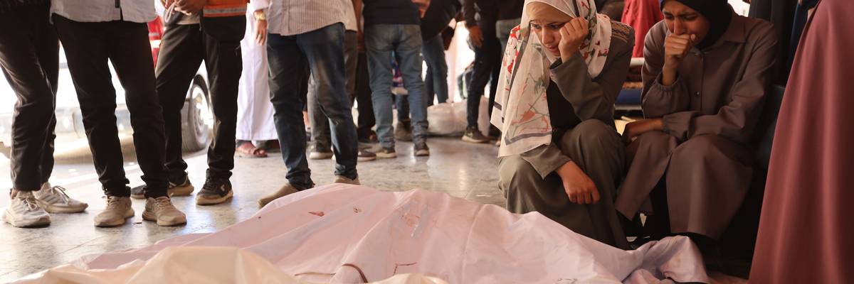 Palestinians mourn relatives killed by an Israeli attack