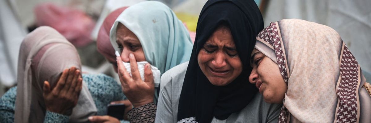 Palestinians mourn their relatives killed in an Israeli bombing