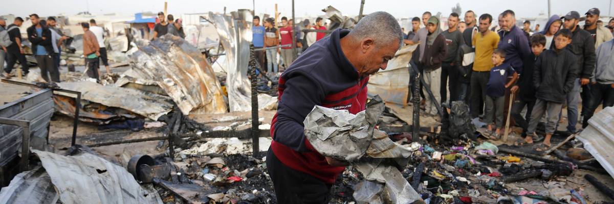 Palestinians observe the destruction caused by Israeli attacks