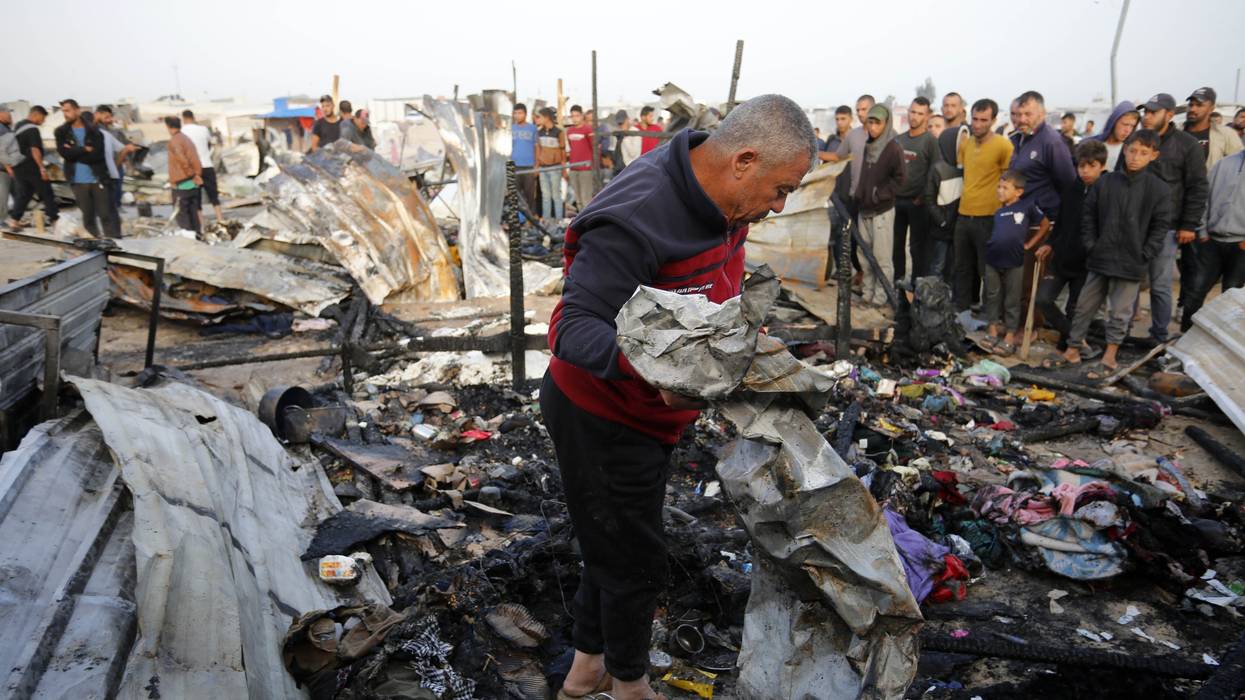 Palestinians observe the destruction caused by Israeli attacks
