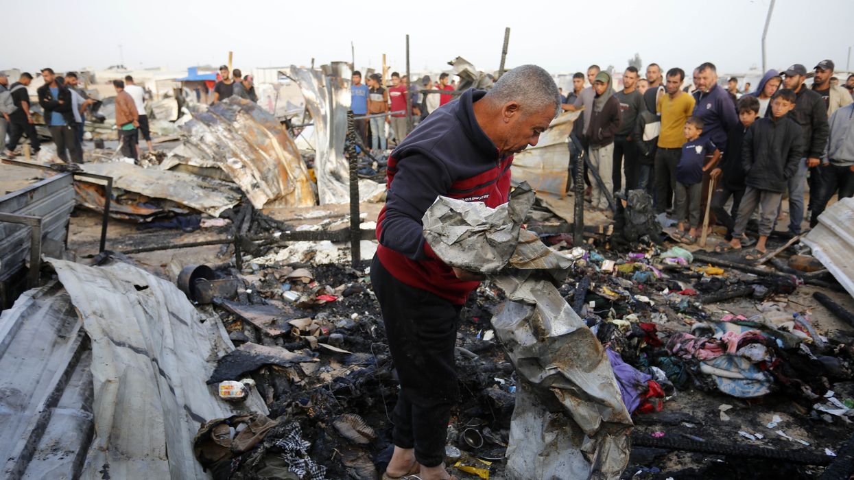 Palestinians observe the destruction caused by Israeli attacks