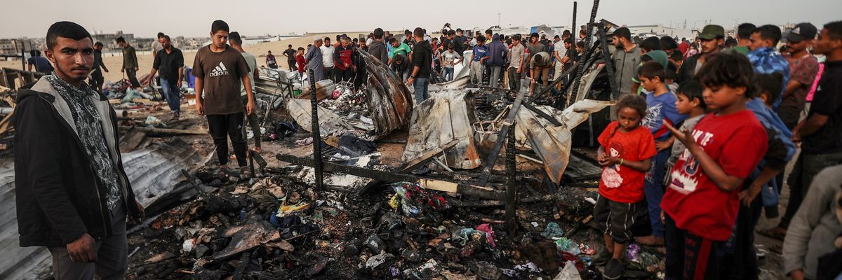 Palestinians observe the destruction caused by the Israeli military's bombing