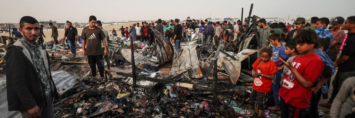 Palestinians observe the destruction caused by the Israeli military's bombing