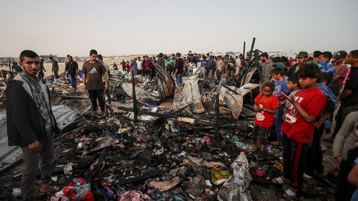 Palestinians observe the destruction caused by the Israeli military's bombing