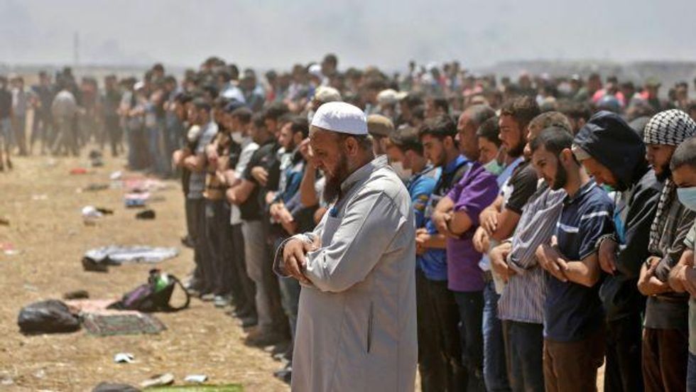 Palestinians pray during clashes with Israeli forces near the border between the Gaza Strip and Israel east of Gaza City on May 14th, during a demonstration on the day of the US embassy move to Jerusalem. Photograph: Mahmud Hams/AFP/Getty