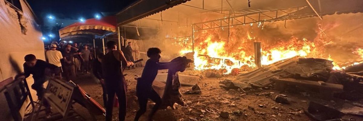 Palestinians react to an Israeli airstrike on a hospital in Gaza