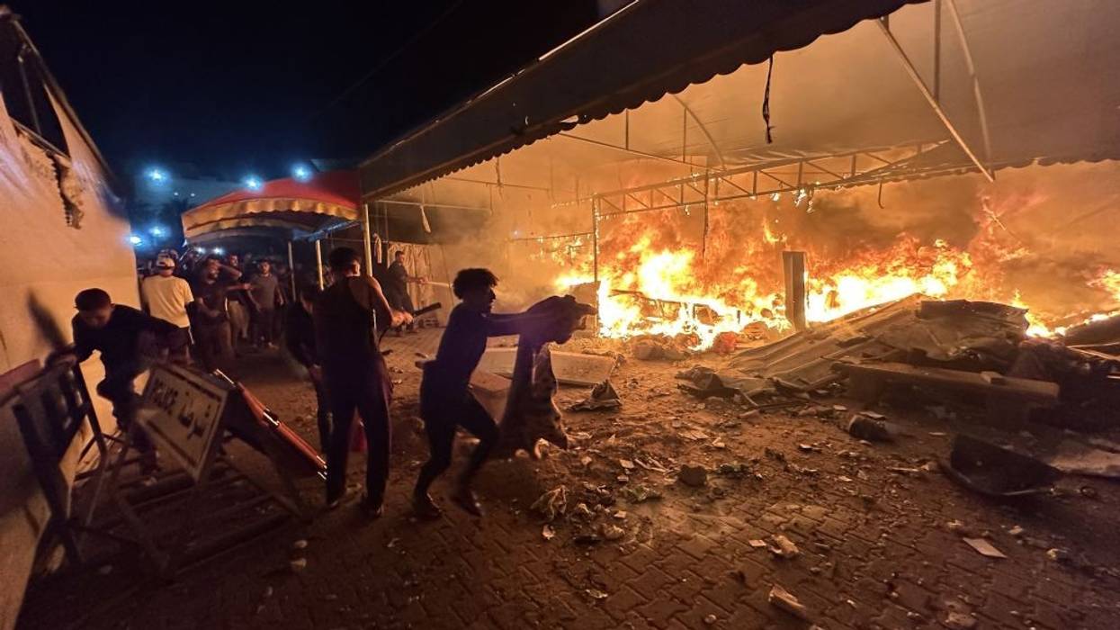 Palestinians react to an Israeli airstrike on a hospital in Gaza
