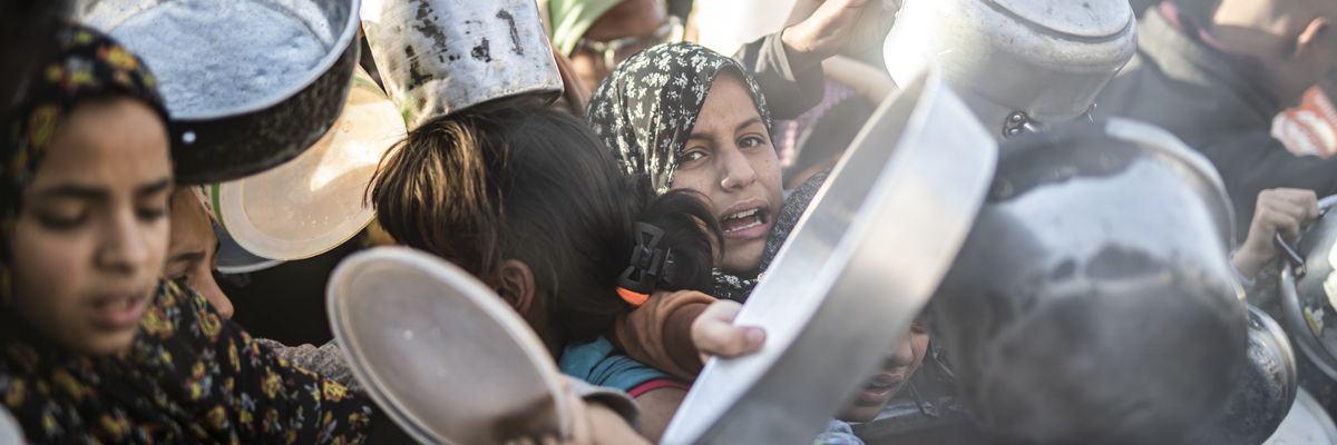 Palestinians receive food in Rafah