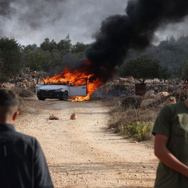 Masked Israeli Settlers Assault Palestinians, Torch Cars in West Bank