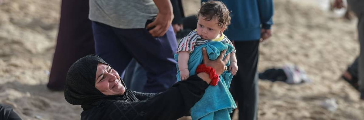 Palestinians try to cool off at the beach