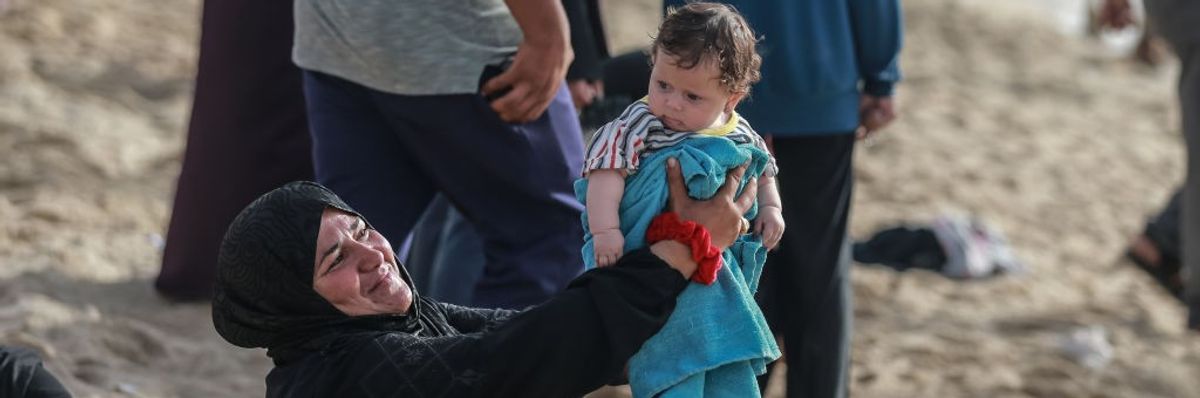 Palestinians try to cool off at the beach