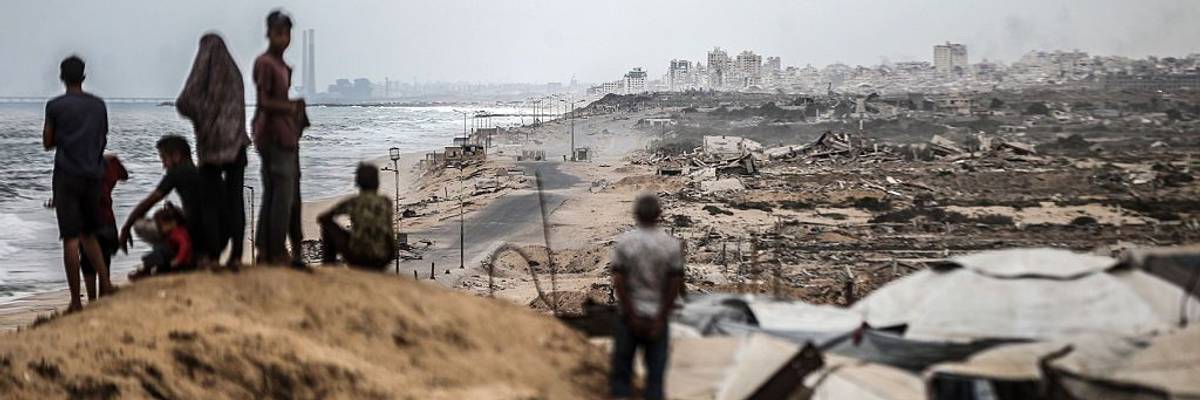 Palestinians wait for the agreed ceasefire to take effect in Gaza