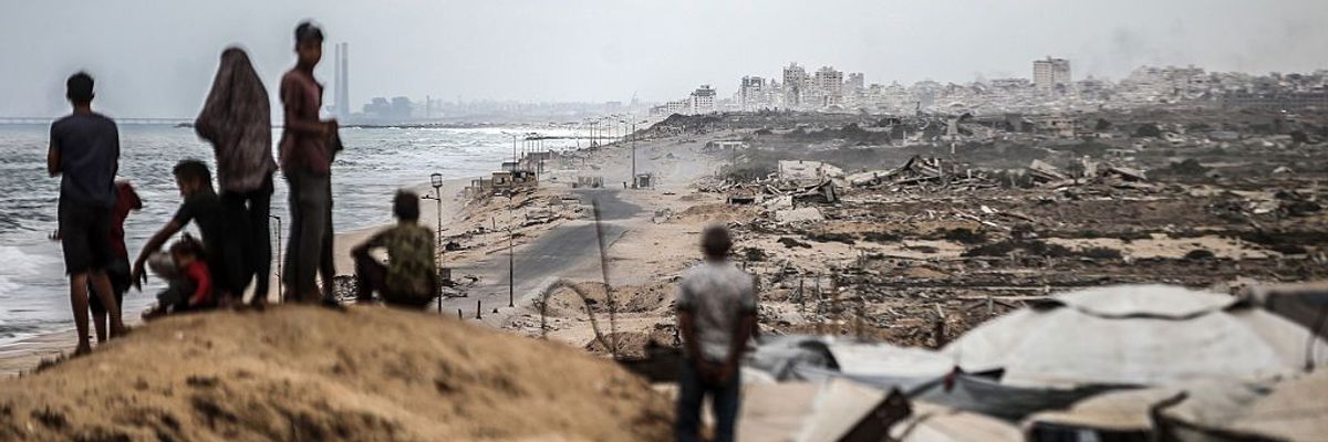 Palestinians wait for the agreed ceasefire to take effect in Gaza