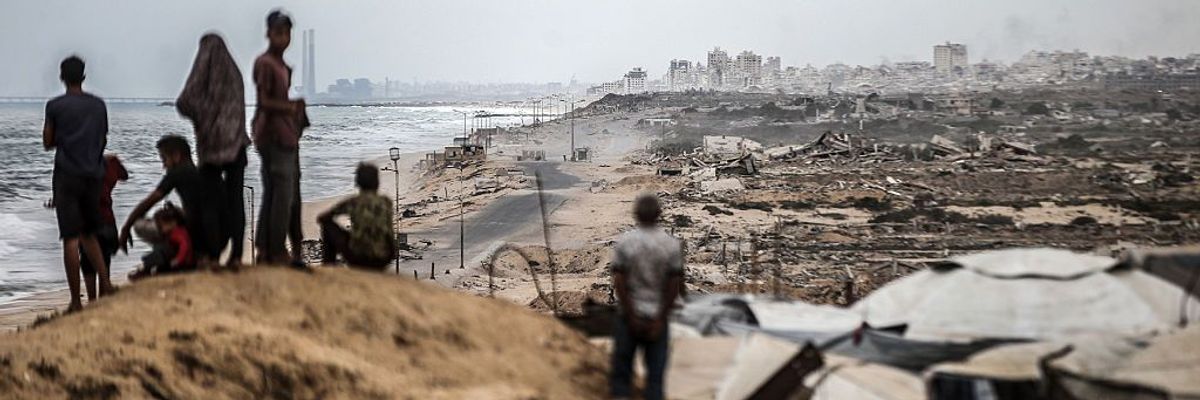 Palestinians wait for the agreed ceasefire to take effect in Gaza