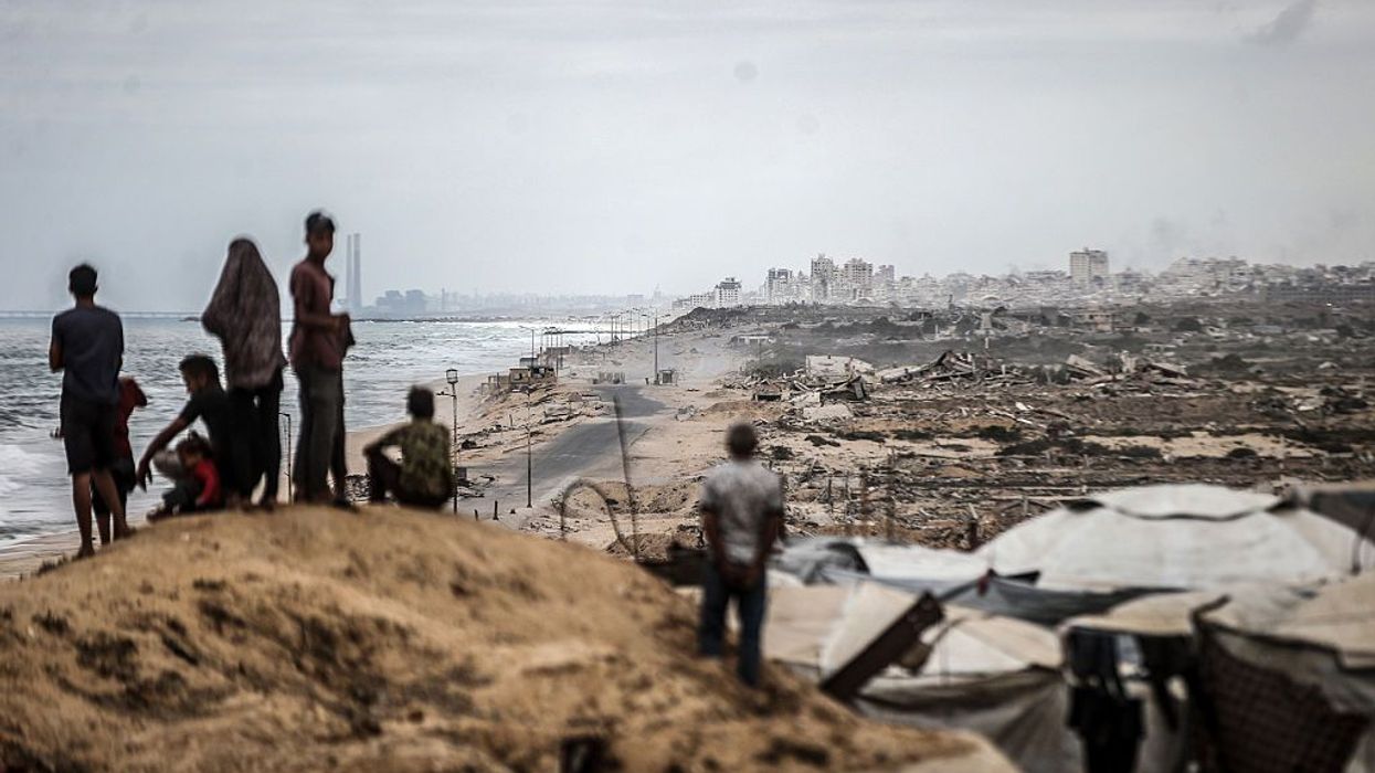Palestinians wait for the agreed ceasefire to take effect in Gaza