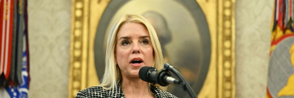 Pam Bondi speaks into a microphone.