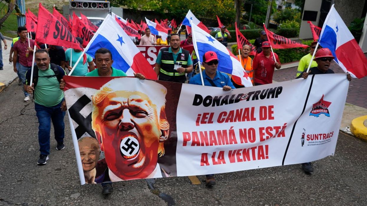 Panamanians march with a banner reading, "Donald Trump, the Panama Canal Is Not for Sale!"