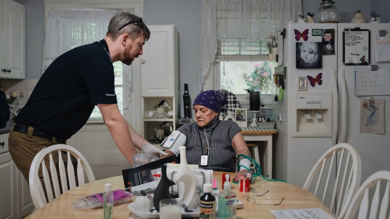 Paramedic treats home patient.