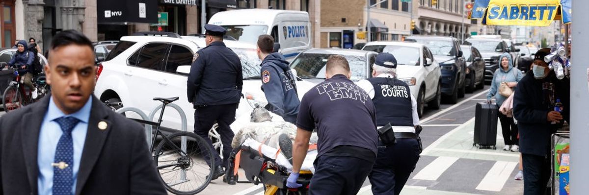 Paramedics attend to a person who lit themself on fire