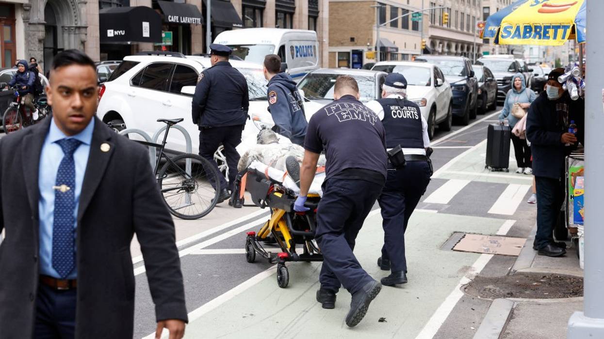 Paramedics attend to a person who lit themself on fire