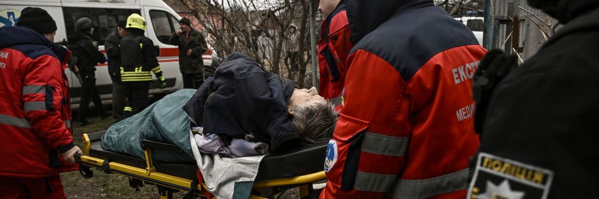 Paramedics evacuate a man injured during a cluster bomb strike in Kramatorsk, Ukraine on March 18, 2023.