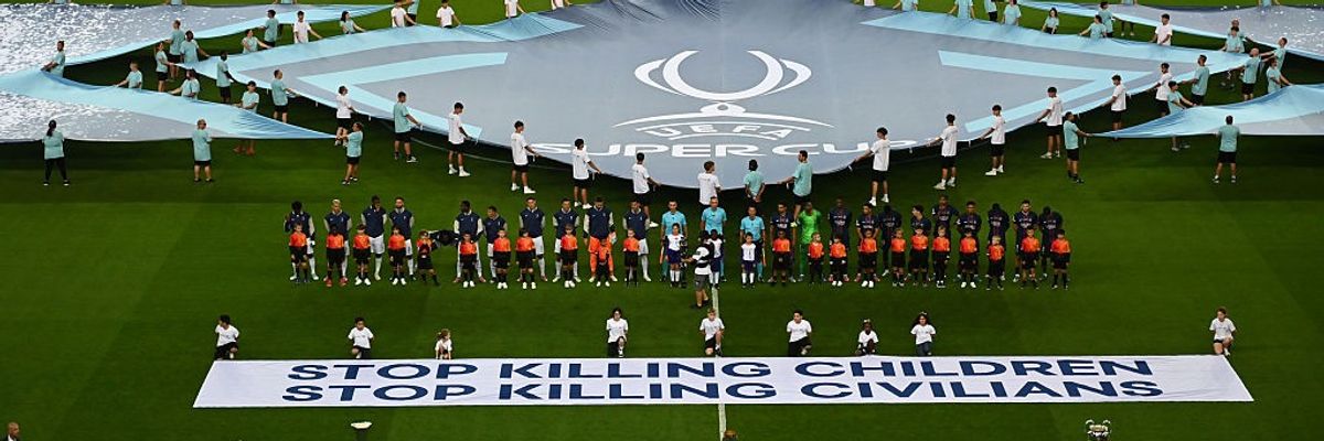 Paris Saint-Germain v Tottenham Hotspur - UEFA Super Cup 2025; banner says "stop killing children, stop killing civilians"