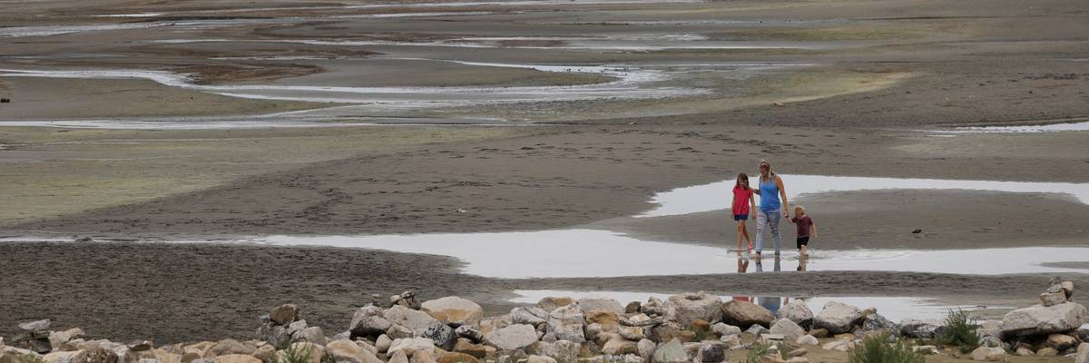 Park visitors walk along a section of the Great Salt Lake that used to be underwater
