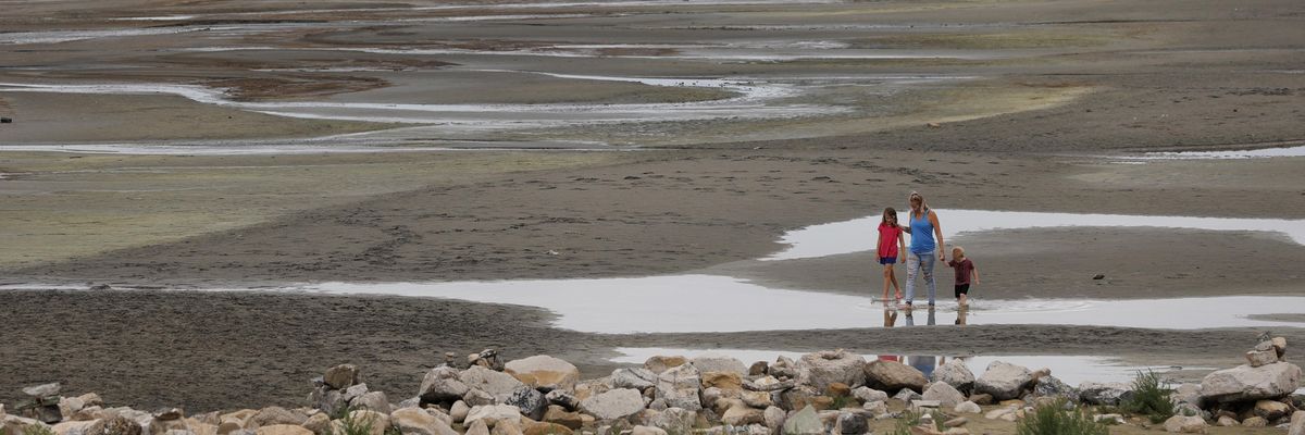 Park visitors walk along a section of the Great Salt Lake that used to be underwater