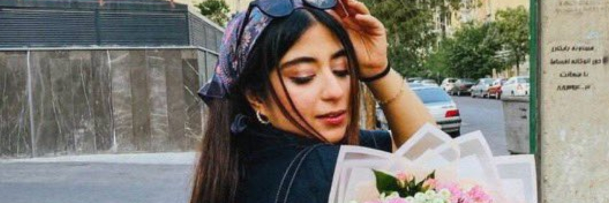 Parnia Abbasi holds a bouquet of flowers