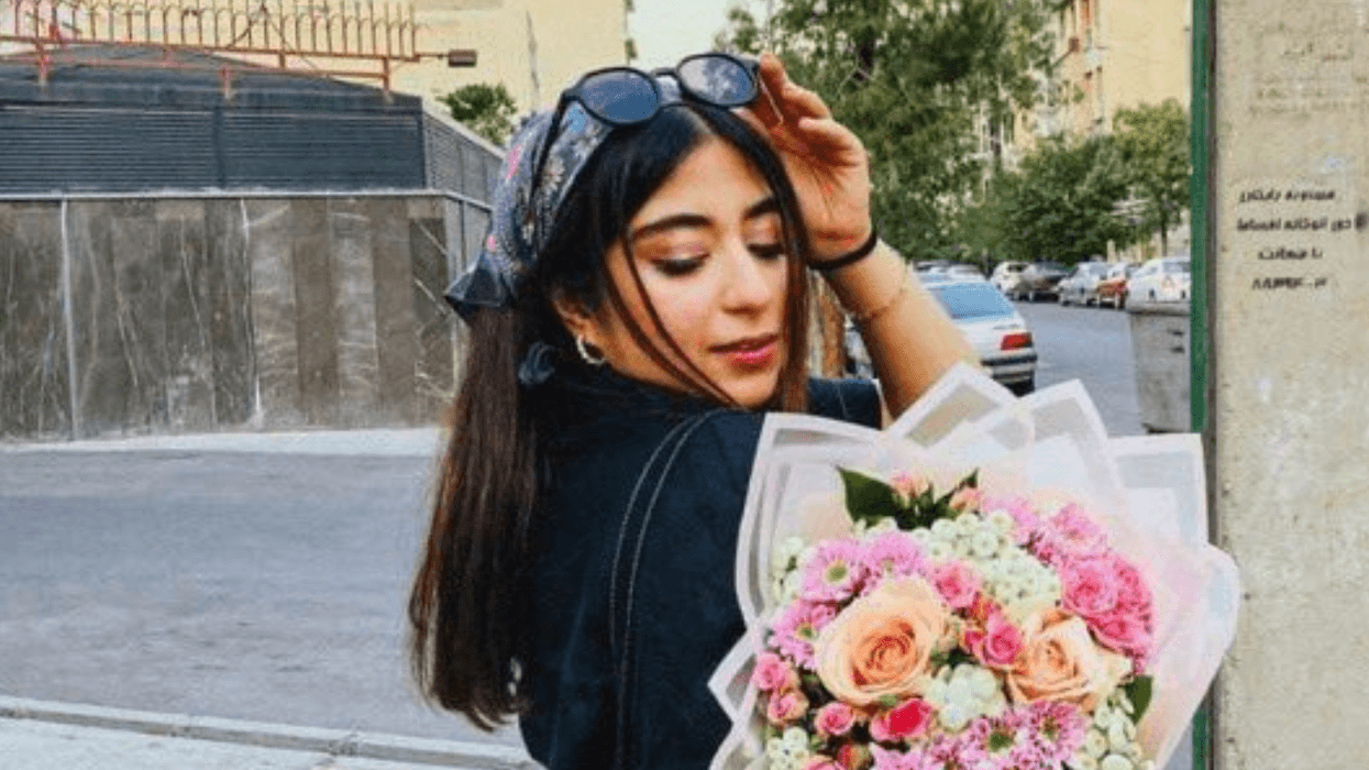 Parnia Abbasi holds a bouquet of flowers