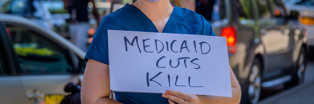 Participant holding a Medicaid Cuts Kill sign at the rally.