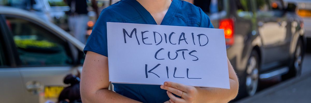 Participant holding a Medicaid Cuts Kill sign at the rally.