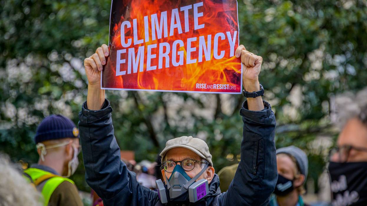 Participant holding a sign at the climate march. A coalition