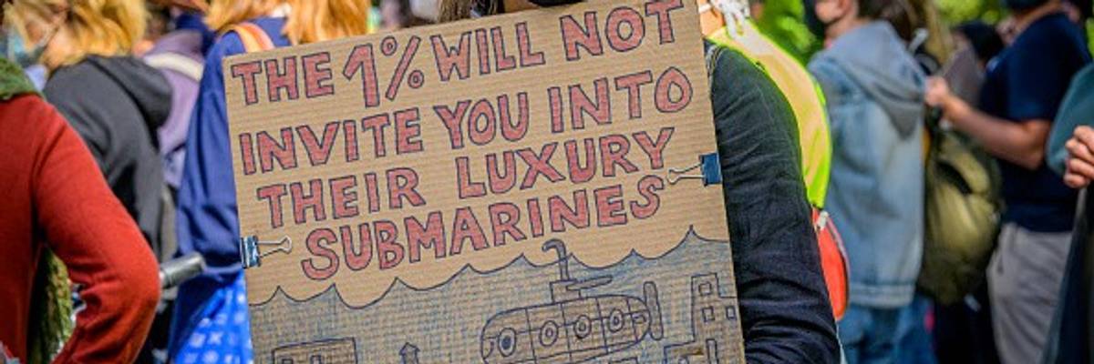 Participant holding a sign at the climate march. A coalition