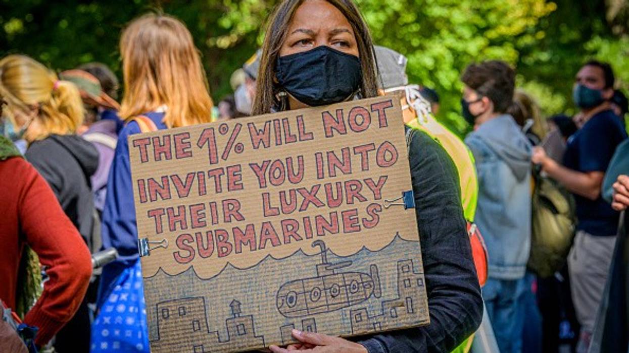 Participant holding a sign at the climate march. A coalition