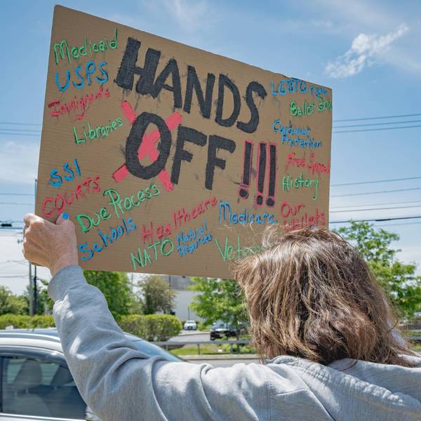 Participant seen holding a sign at the protest. A large