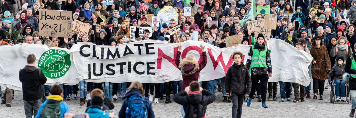 Participants at a Fridays for Future demonstration hold a banner with the inscription "Climate Justice Now" in Munich, Germany, on November 29, 2019.