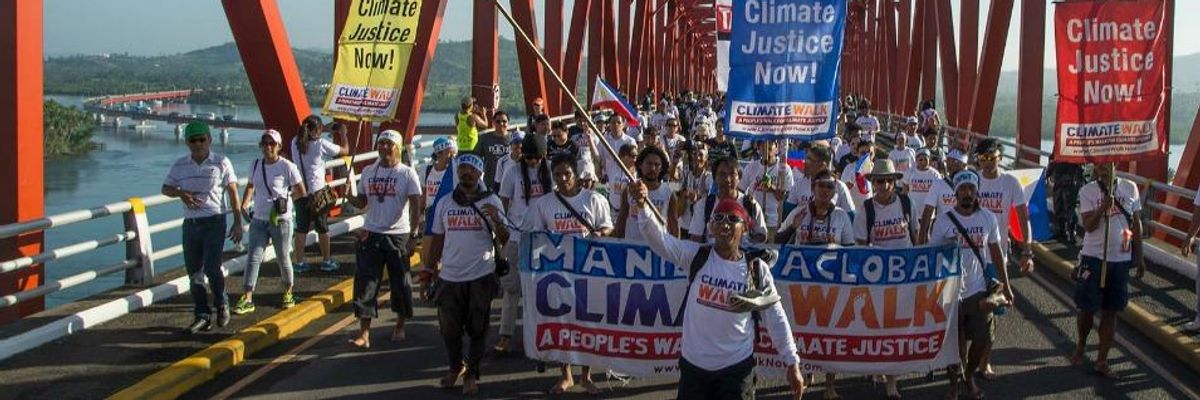 After Carrying Their Message Hundreds of Miles, Climate Walkers Reach Typhoon's 'Ground Zero'