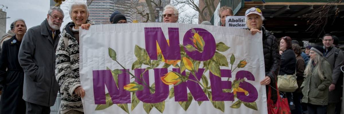 Participants seen holding a banner at the protest. At a time...