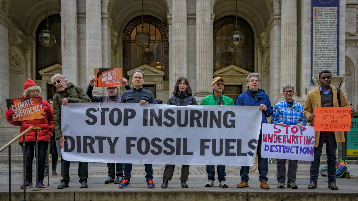 Participants seen holding a banner at the protest. Climate