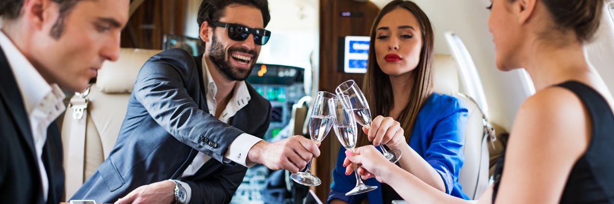 passengers toast champagne on a private jet